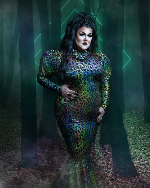 Abby in a jewel-toned gown in a misty forest